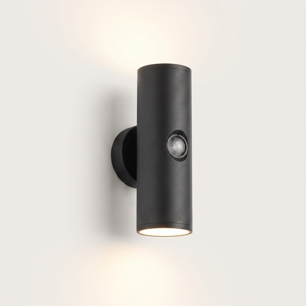 Vega up-and-down outdoor wall light lit warm on a soft off-white studio background