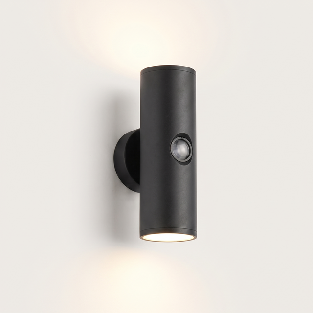 Vega up-and-down outdoor wall light lit warm on a soft off-white studio background