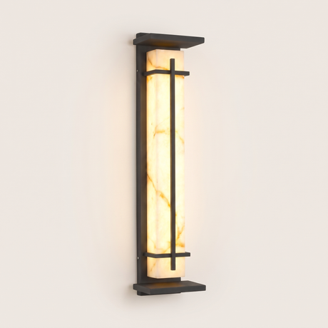 Luminara marble-panel outdoor wall sconce lit warm on a soft off-white studio background