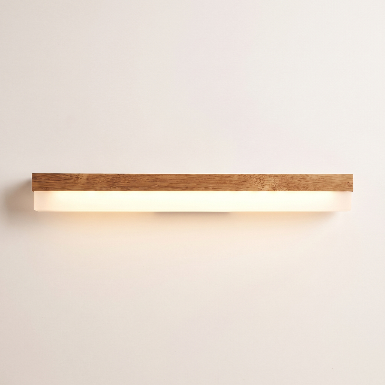 Nara oak LED vanity light bar lit warm on a soft off-white studio background