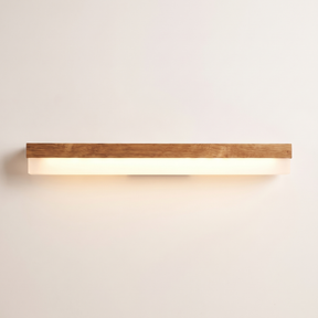 Nara oak LED vanity light bar lit warm on a soft off-white studio background
