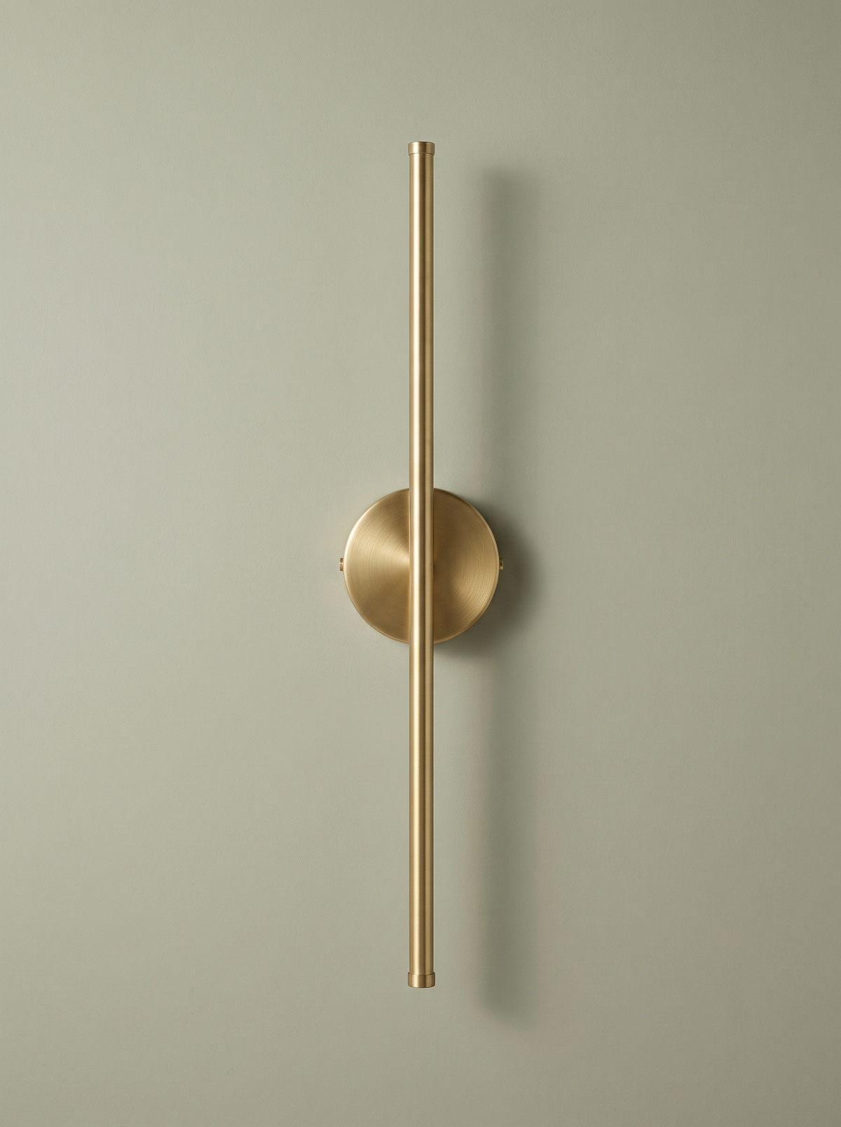 Tarn slim LED wall sconce in brushed brass on a sage backdrop