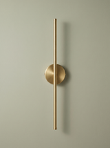 Tarn slim LED wall sconce in brushed brass on a sage backdrop