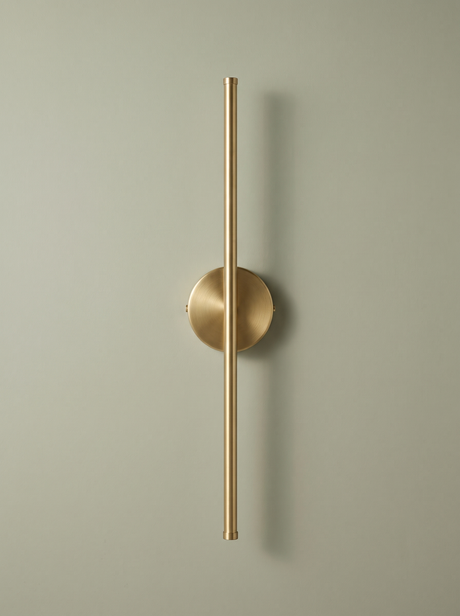 Tarn slim LED wall sconce in brushed brass on a sage backdrop