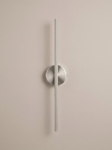 Tarn slim LED wall sconce in brushed nickel on a greige backdrop