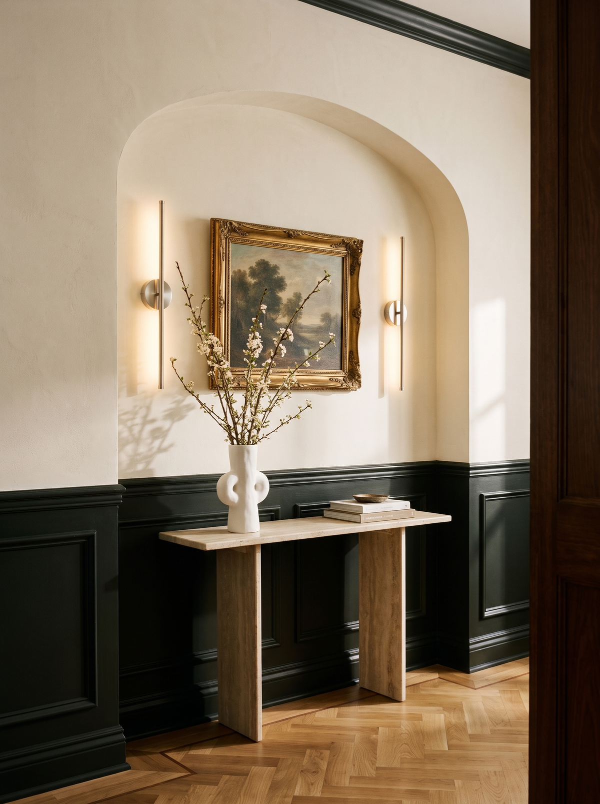 Lifestyle: pair of nickel Tarn wall sconces flanking a gilt landscape painting in an arched entry, shown to scale