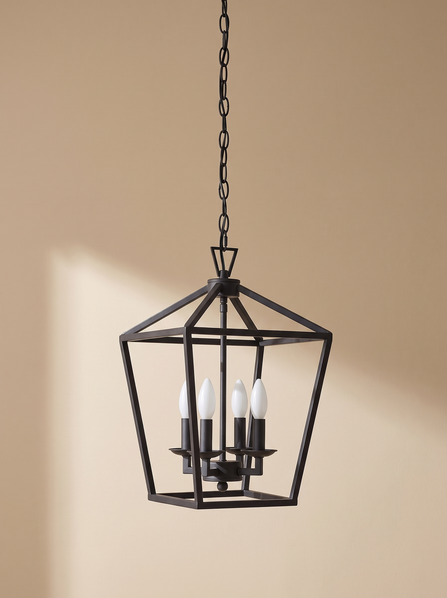 Kiel 4-light lantern pendant in matte black on a warm sand backdrop