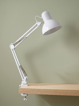 Otis architect clamp lamp in white on a sage green backdrop