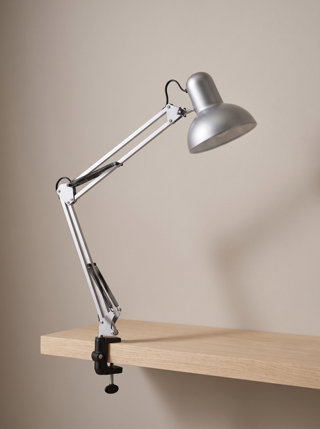 Otis architect clamp lamp in silver on a warm greige backdrop