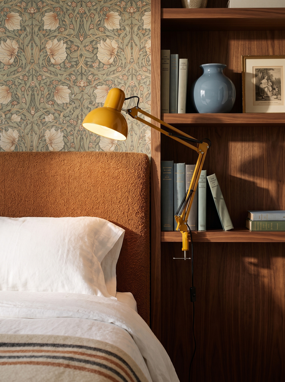 Lifestyle: Otis architect clamp lamp in yellow clamped to a bedside bookcase