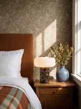 Lifestyle: Dessa marble table lamp on a nightstand with floral wallpaper showing its size