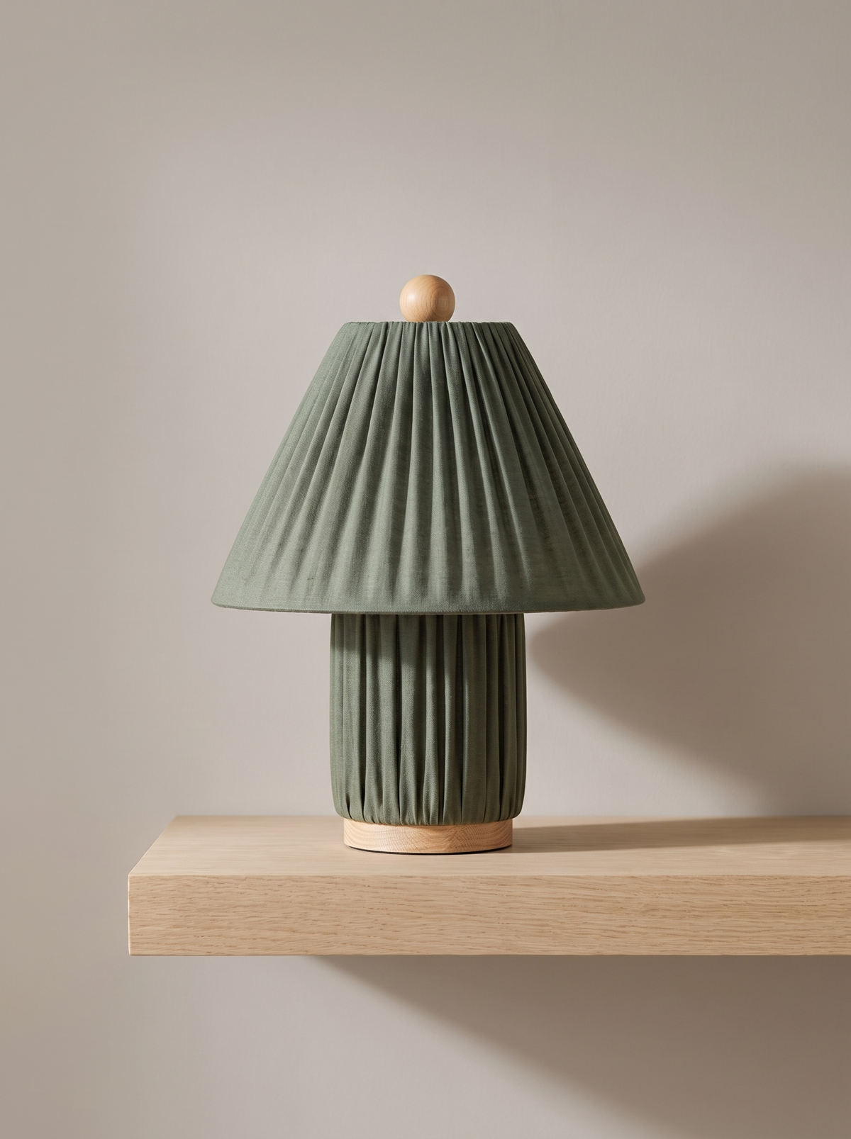 Esme table lamp in dark green on a greige backdrop