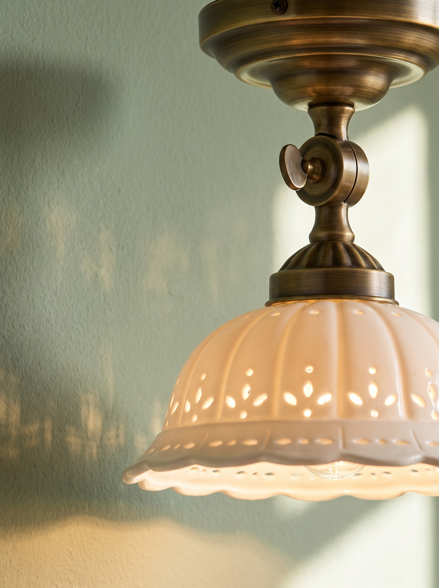 Lifestyle: Colette ceiling light detail, pierced porcelain shade and brass fitting
