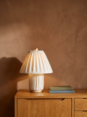 Esme pleated linen table lamp on an oak console against a warm plaster wall