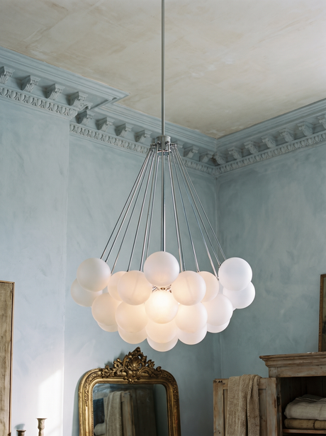 Perle chandelier in chrome with frosted glass globes in a blue-grey plaster corner