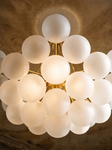 Lifestyle: close-up of Perle's frosted glass globes and fine gold rods