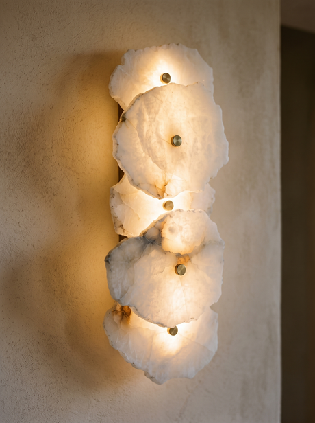 Lifestyle: close-up of Seren's veined alabaster discs and brass pins, lit