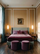 Lifestyle: a pair of Sola alabaster pendants beside a bed in a camel-panelled bedroom, showing their size