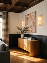 Lifestyle: a pair of Aurelie sconces flanking a painting above an oak sideboard