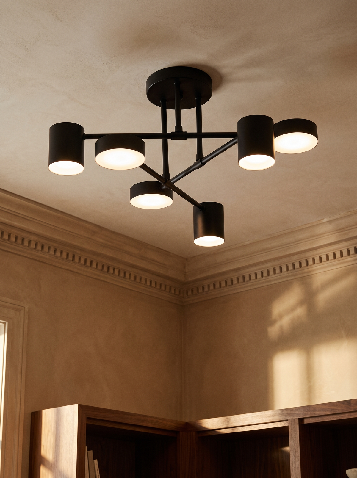 Lys sputnik semi-flush ceiling light in black in a caramel plaster corner