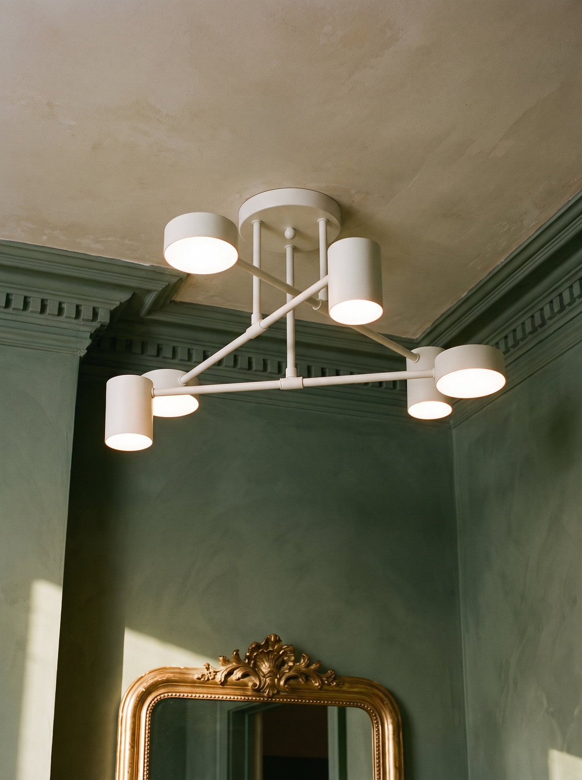 Lys sputnik semi-flush ceiling light in white in a sage plaster corner