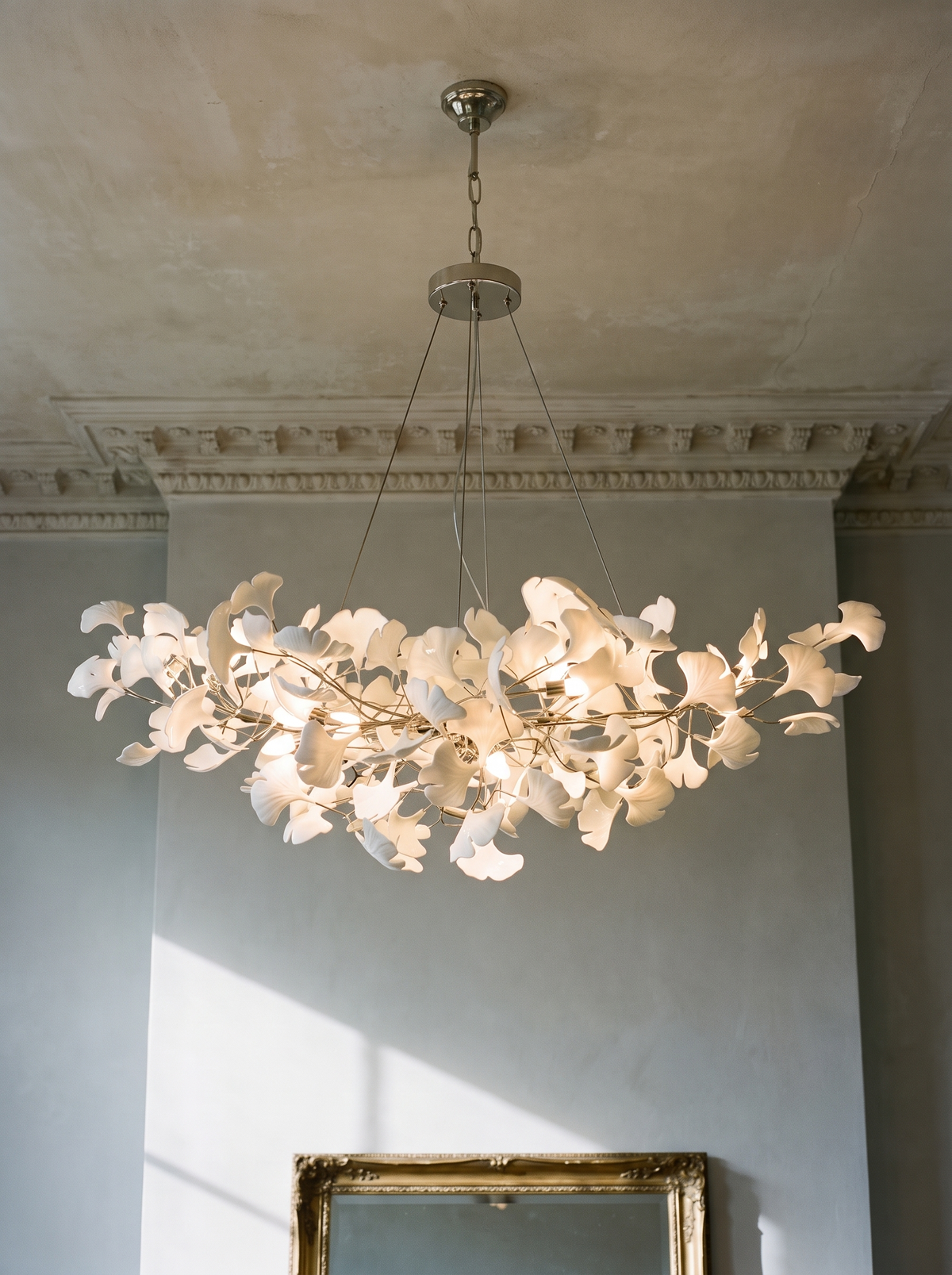 Ginevra porcelain ginkgo leaf chandelier in nickel against dove-grey plaster