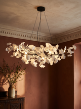 Ginevra porcelain ginkgo leaf chandelier in black against terracotta plaster