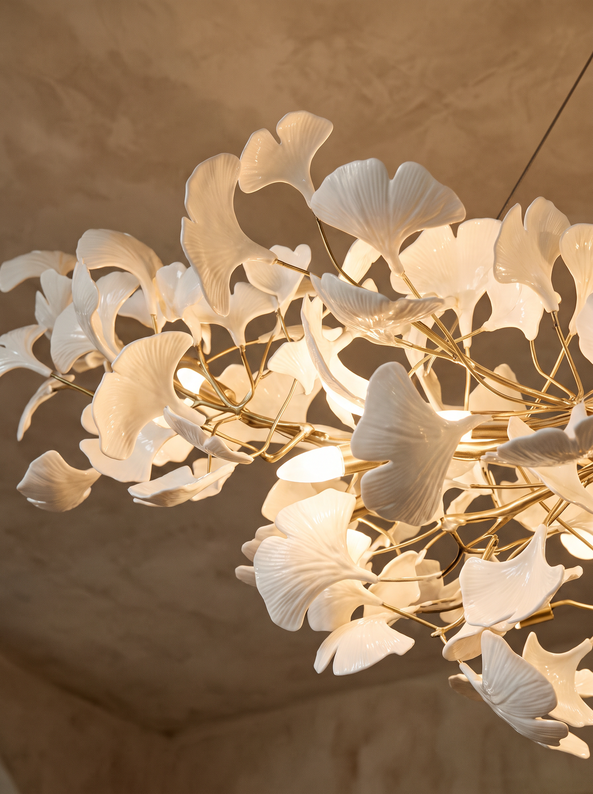 Lifestyle: close-up of Ginevra's hand-formed porcelain ginkgo leaves, lit