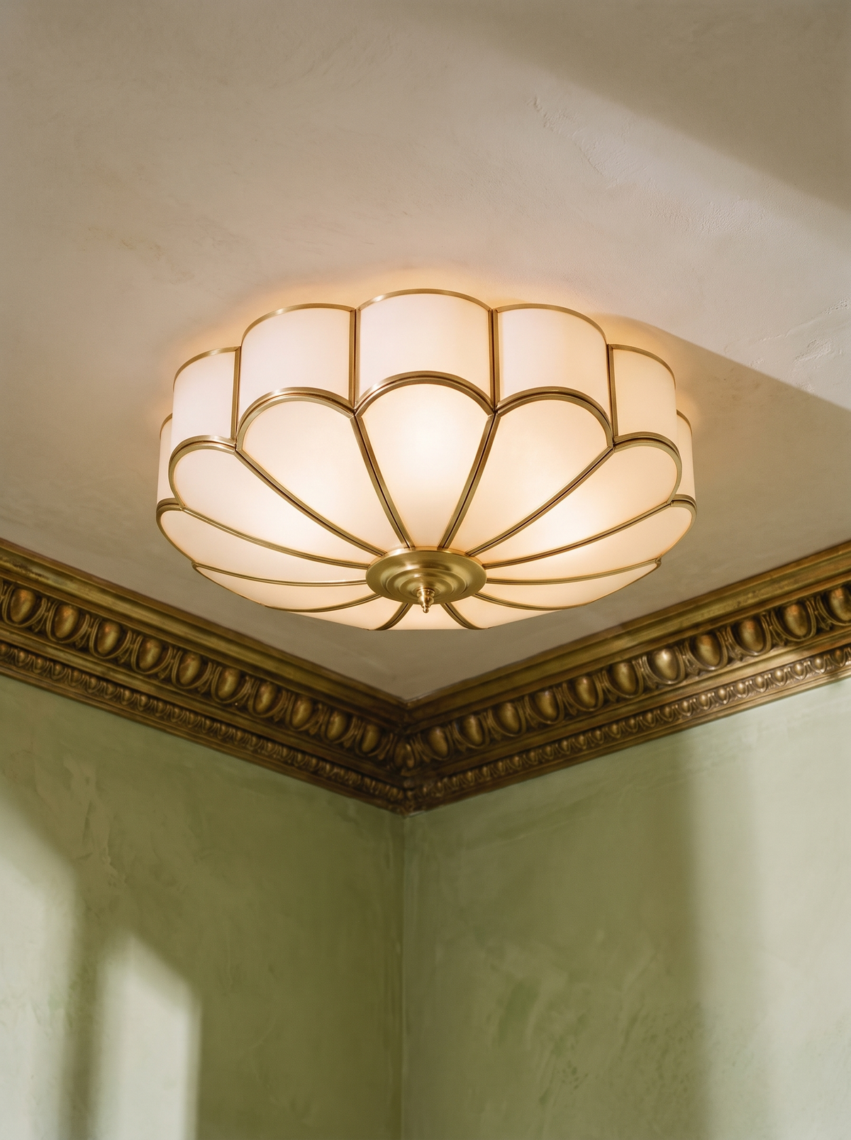 Marguerite frosted glass flower flush mount ceiling light in brass in a plaster-moulded corner