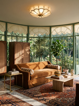 Lifestyle: Marguerite flower ceiling light in a green steel-framed conservatory sitting room