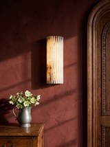 Clio ribbed alabaster wall sconce on an oxblood plaster wall