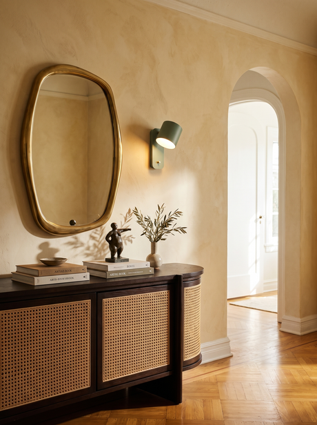 Lifestyle: Tate swivel wall lamp beside a brass mirror in a plaster entry, showing its size