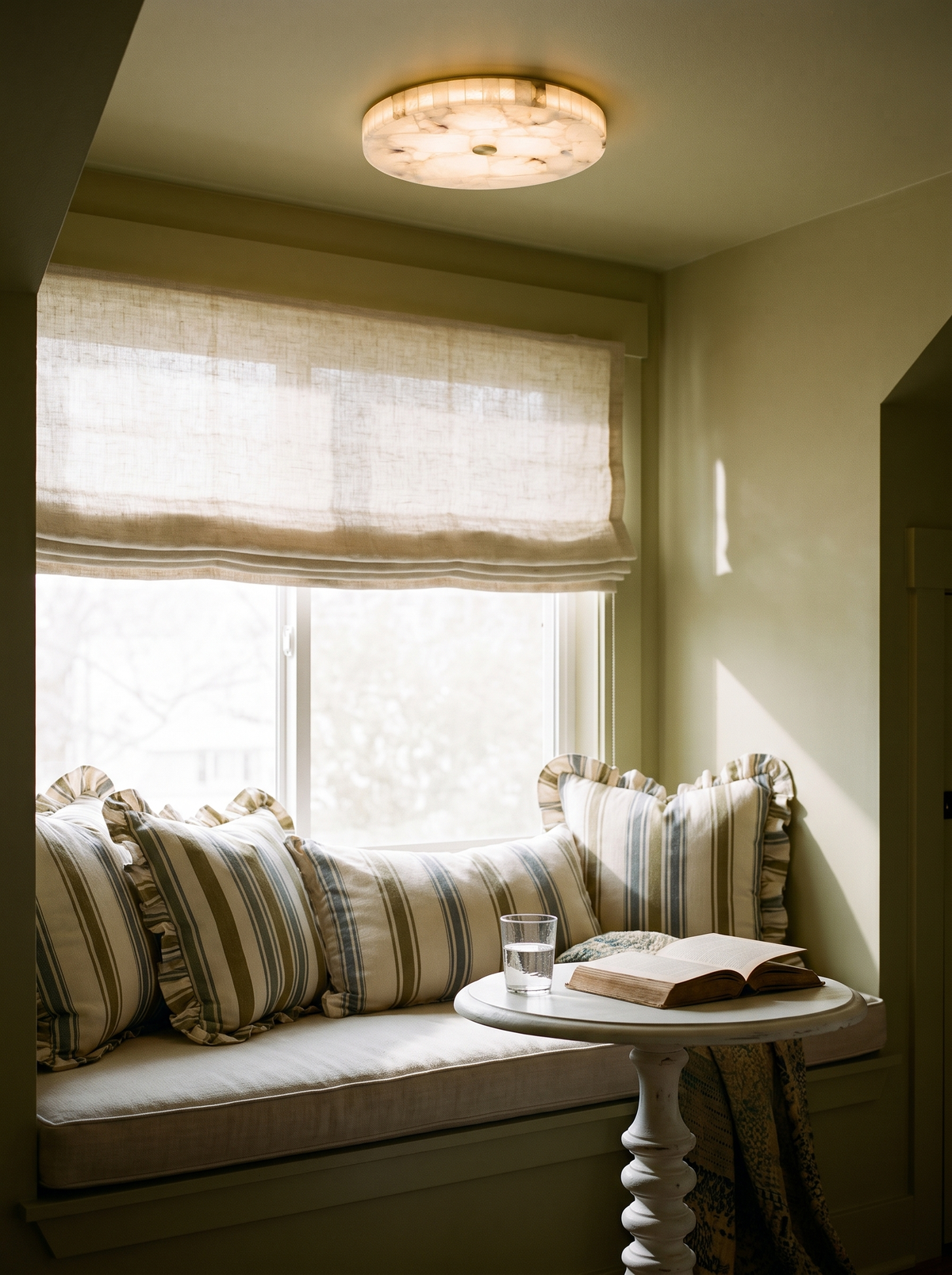Lifestyle: Opal alabaster ceiling light above a window seat in an olive reading nook