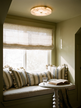 Lifestyle: Opal alabaster ceiling light above a window seat in an olive reading nook