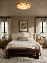 Lifestyle: Opal alabaster ceiling light in a taupe bedroom with a botanical print