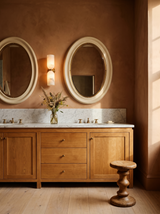 Lifestyle: a pair of Nyx alabaster sconces between oval mirrors above a double vanity