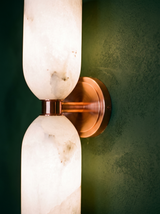 Lifestyle: close-up of Nyx's copper collar between the alabaster columns