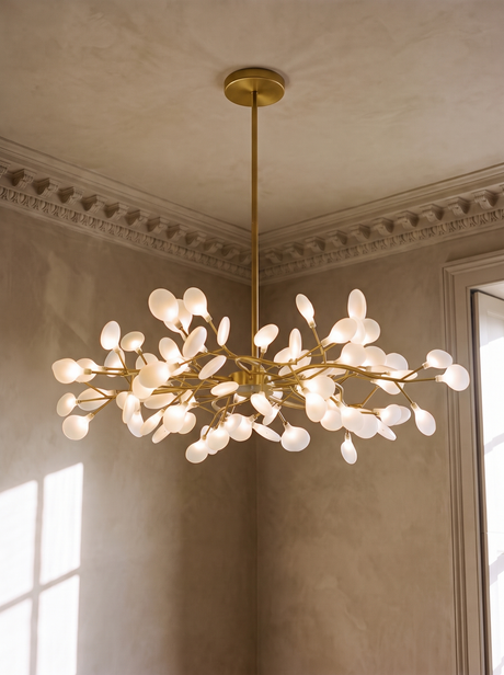Luce 54-light firefly chandelier in gold hanging in a plaster-moulded corner