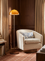 Lifestyle: Briar floor lamp beside a cream swivel chair in a walnut-panelled den