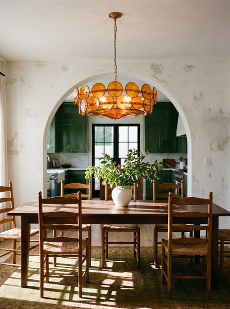Lifestyle: Soleil amber disc chandelier above a walnut dining table by a green kitchen arch