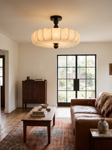 Lifestyle: Posy scalloped ceiling light in a living room with a cognac leather sofa, showing its size
