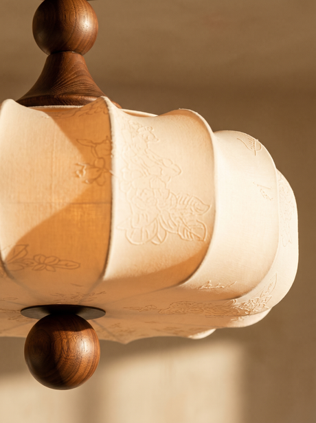 Lifestyle: close-up of Posy's embossed floral fabric and walnut finial, lit