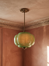 Ivy tall green glass semi-flush ceiling light in gold hanging in a plaster-moulded corner