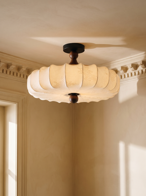 Posy scalloped fabric semi-flush ceiling light with walnut stem in a plaster-moulded corner