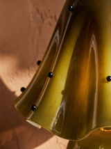 Lifestyle: close-up of Petal's draped glass folds and beads, lit
