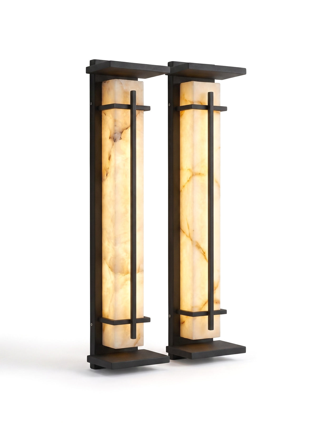 A matched pair of Luminara sconces on white, glowing warm