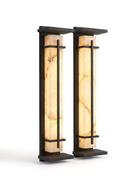 A matched pair of Luminara sconces on white, glowing warm