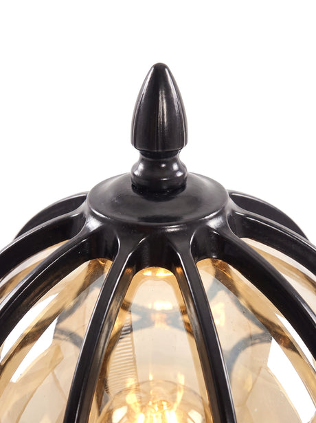 Lune black finial and cage apex with warm amber glow, close-up on pure white