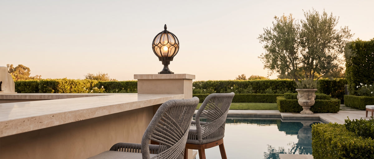 Lune pillar lantern with woven-rope bar stools, wide poolside terrace at golden hour — lifestyle