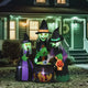 Inflatable cauldron with bubbling green potion at night